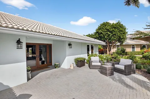 a view of a dining room with furniture a chandelier and wooden floor