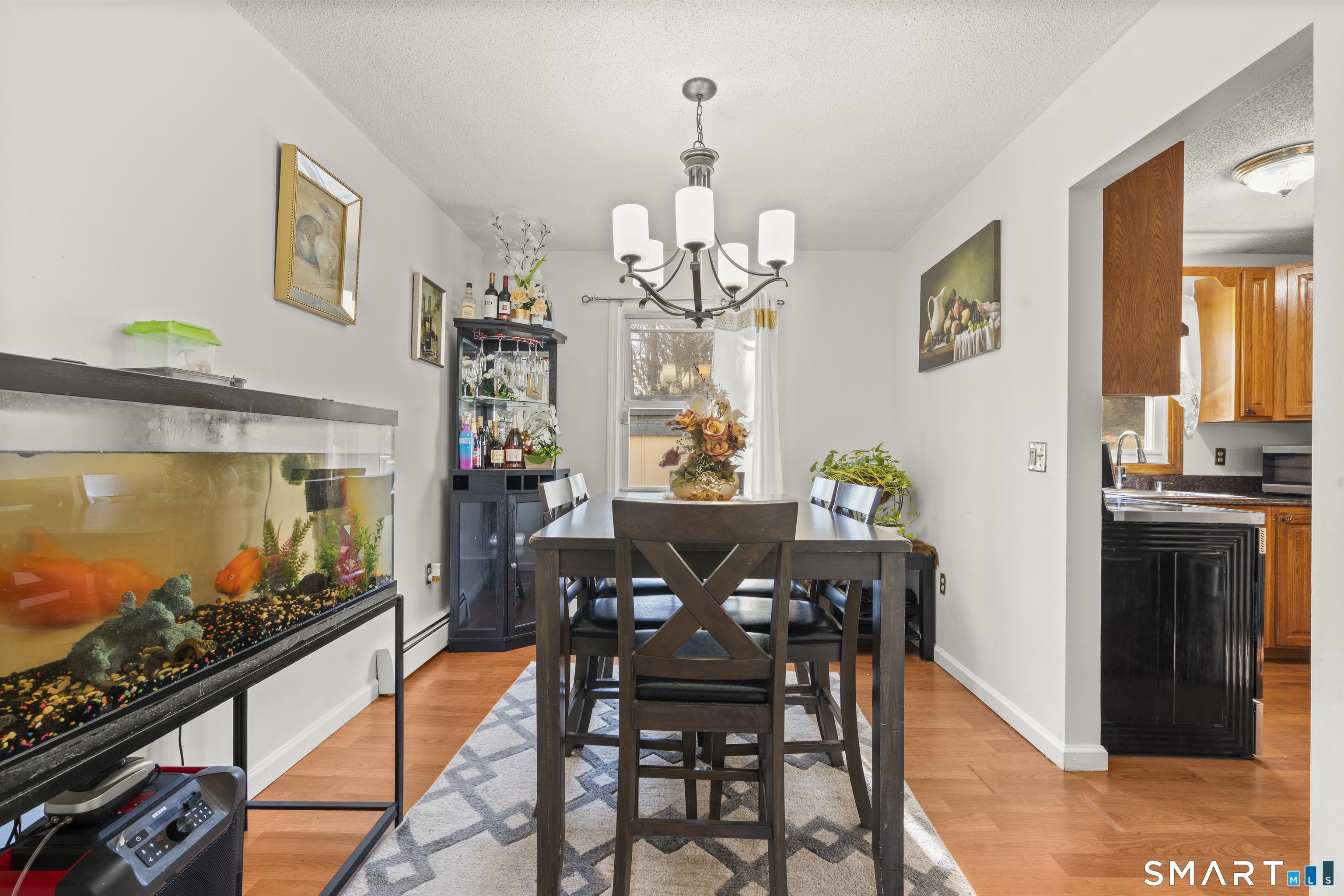 15 Kenneth Circle Waterbury, CT 06710 - Photo 13 of 31 a view of a dining room with furniture a chandelier and wooden floor