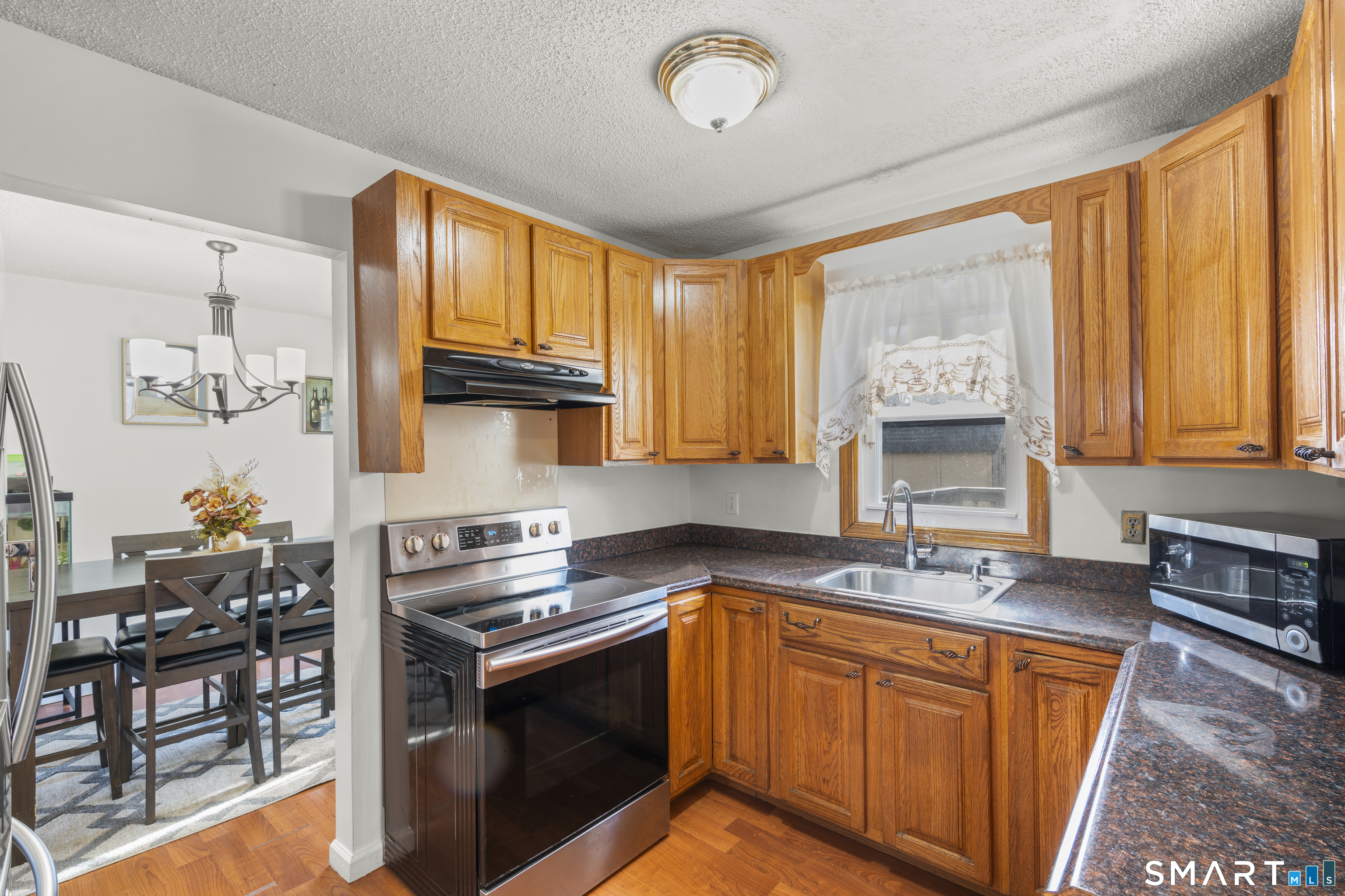 15 Kenneth Circle Waterbury, CT 06710 - Photo 14 of 31 a kitchen with stainless steel appliances granite countertop a sink stove and cabinets