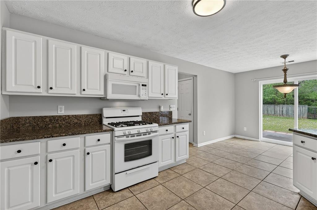45 Polo Fields Northeast Cartersville, GA 30121 - Photo 14 of 49 a kitchen with white cabinets and white appliances
