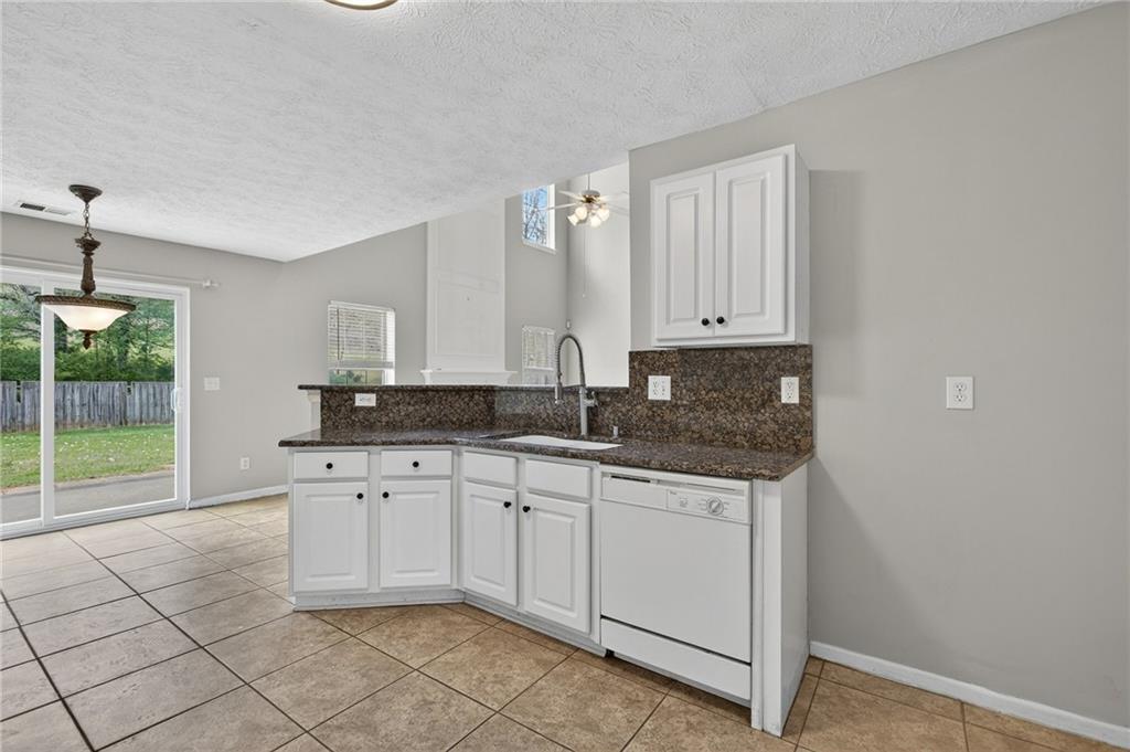 45 Polo Fields Northeast Cartersville, GA 30121 - Photo 15 of 49 a kitchen with granite countertop white cabinets and a sink