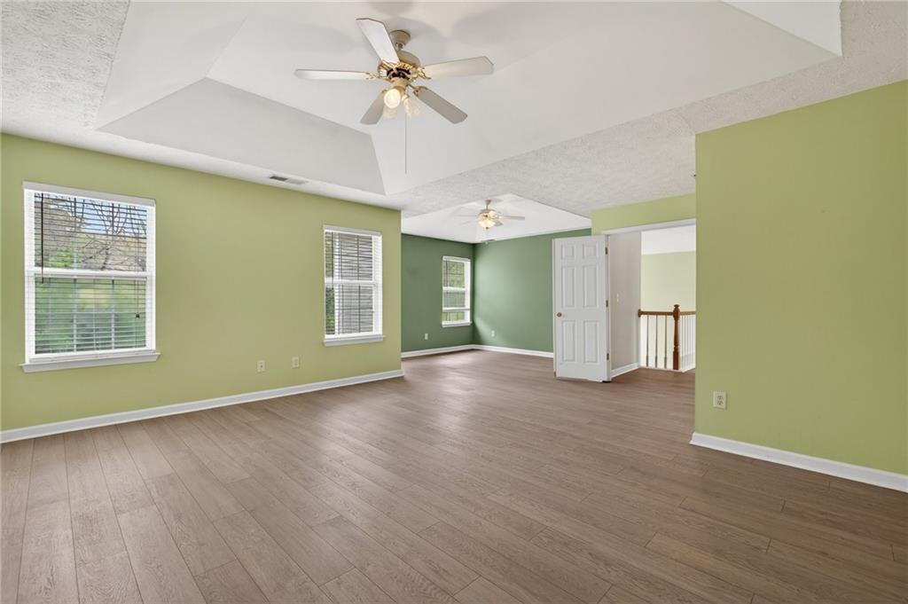45 Polo Fields Northeast Cartersville, GA 30121 - Photo 31 of 49 a view of an empty room with a window and wooden floor