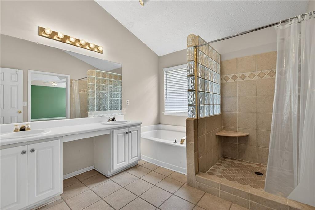 45 Polo Fields Northeast Cartersville, GA 30121 - Photo 34 of 49 a bathroom with a double vanity sink a toilet and shower