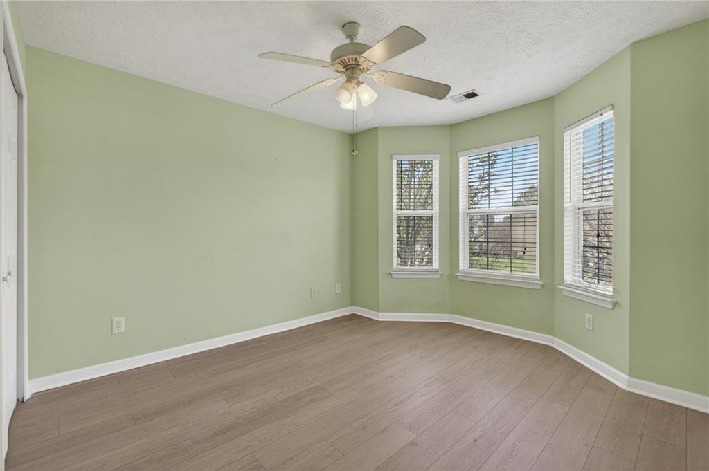 45 Polo Fields Northeast Cartersville, GA 30121 - Photo 41 of 49 an empty room with wooden floor and windows
