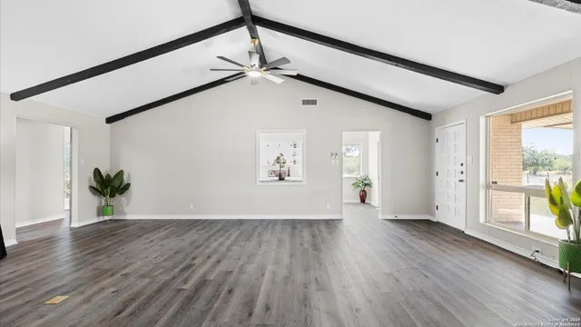 a view of an entryway with wooden floor