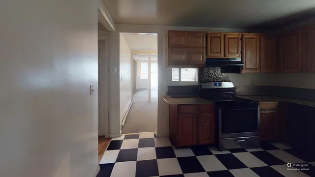 a kitchen with a black white checkered cabinets and black appliances