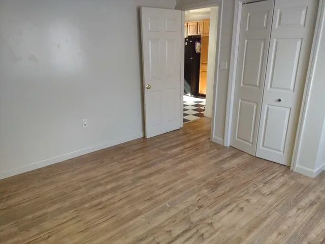 a view of a room with wooden floor