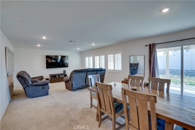 a living room with furniture a flat screen tv and wooden floor