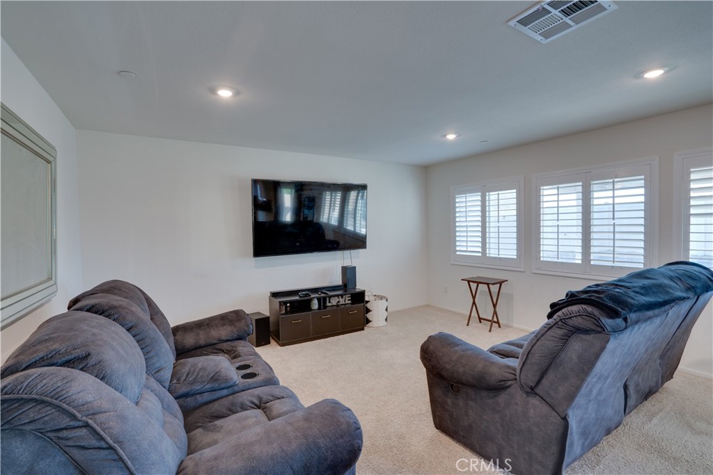 1328 Prosperity Place Hemet, CA 92543 - Photo 16 of 40 a living room with furniture and a flat screen tv