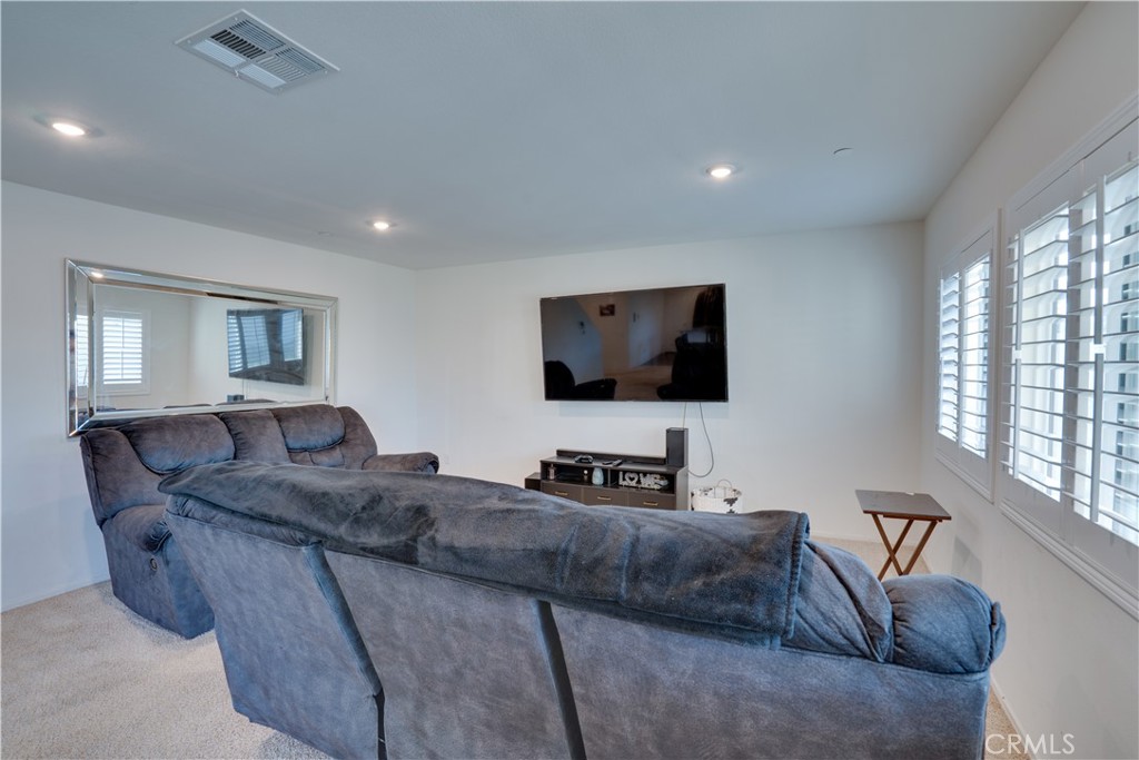 1328 Prosperity Place Hemet, CA 92543 - Photo 17 of 40 a living room with furniture and a flat screen tv