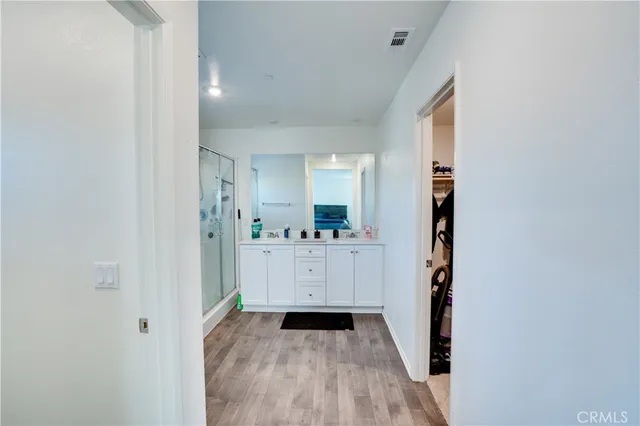 a bathroom with a double vanity sink mirror and shower