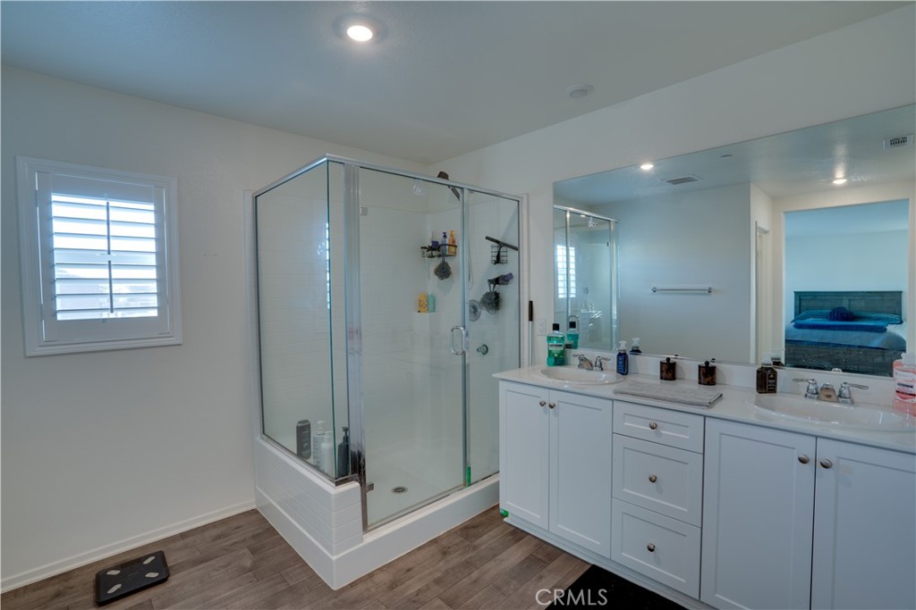 1328 Prosperity Place Hemet, CA 92543 - Photo 23 of 40 a bathroom with a double vanity sink mirror and shower