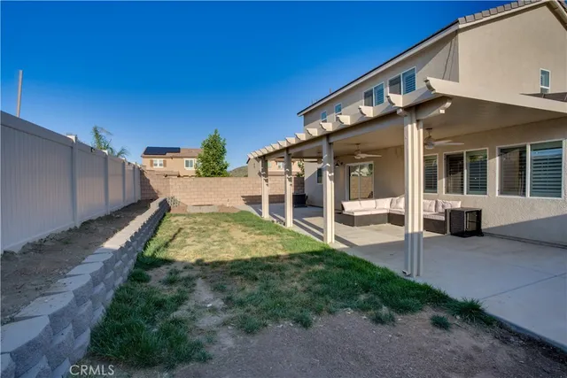 a view of backyard of house with green space