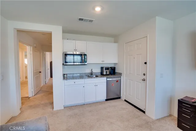 a kitchen with cabinets and a stove