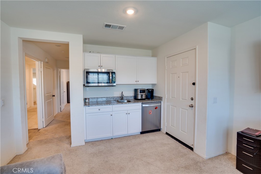 1328 Prosperity Place Hemet, CA 92543 - Photo 5 of 40 a kitchen with cabinets and a stove