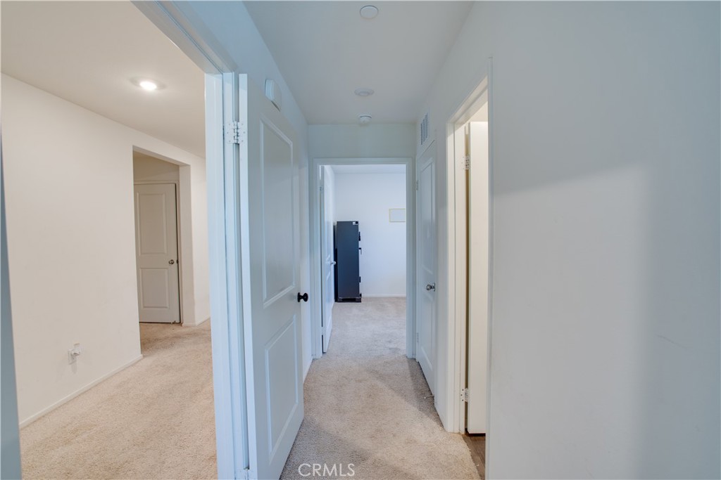 1328 Prosperity Place Hemet, CA 92543 - Photo 7 of 40 a view of a hallway with wooden shelves