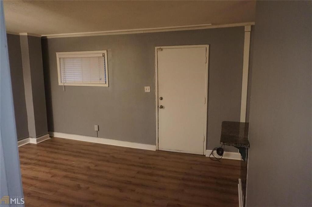 699 Argonne Avenue Northeast, Unit 4 Atlanta, GA 30308 - Photo 3 of 6 an empty room with wooden floor and closet