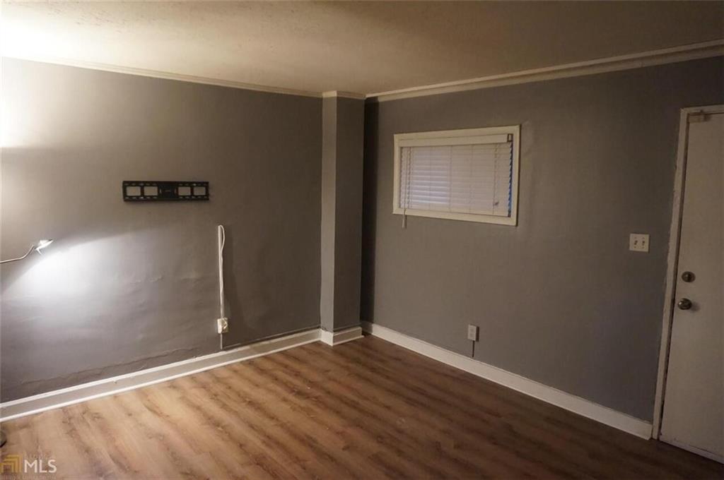 699 Argonne Avenue Northeast, Unit 4 Atlanta, GA 30308 - Photo 4 of 6 an empty room with wooden floor and windows