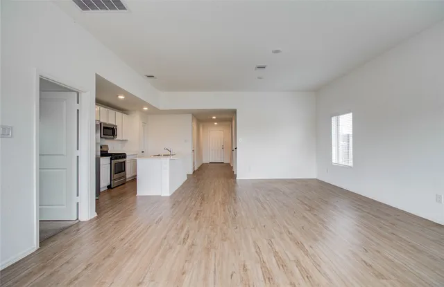 a view of a kitchen with wooden floor and a kitchen