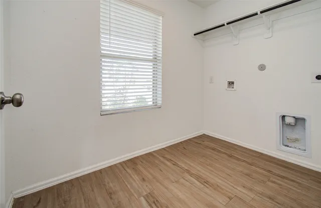 a view of a small space with wooden floor and a window