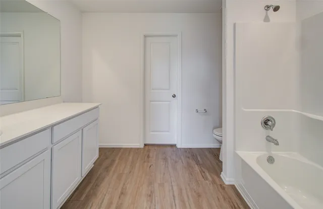 a bathroom with a sink a bathtub and a shower