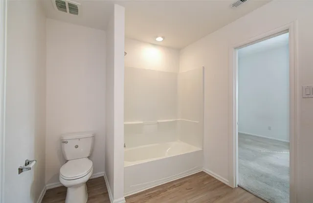 a bathroom with a toilet and a bathtub