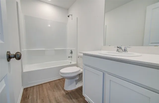 a bathroom with a sink a toilet and a bathtub