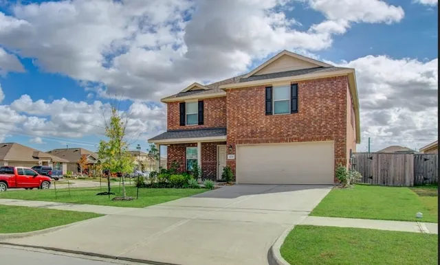 a front view of house with yard and green space