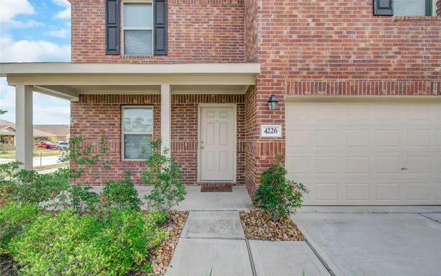 a view of entrance of the house with potted plants