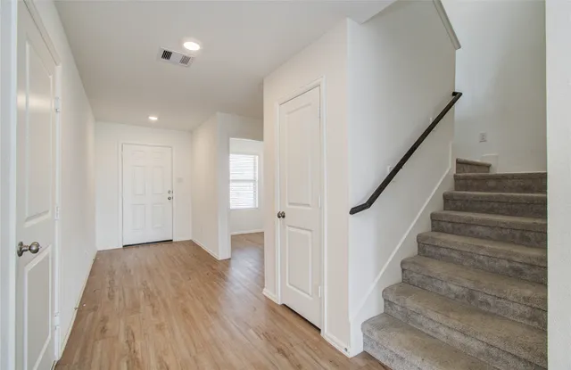 a view of an entryway with wooden floor