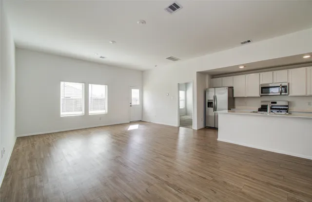 a view of a kitchen with a sink and a window