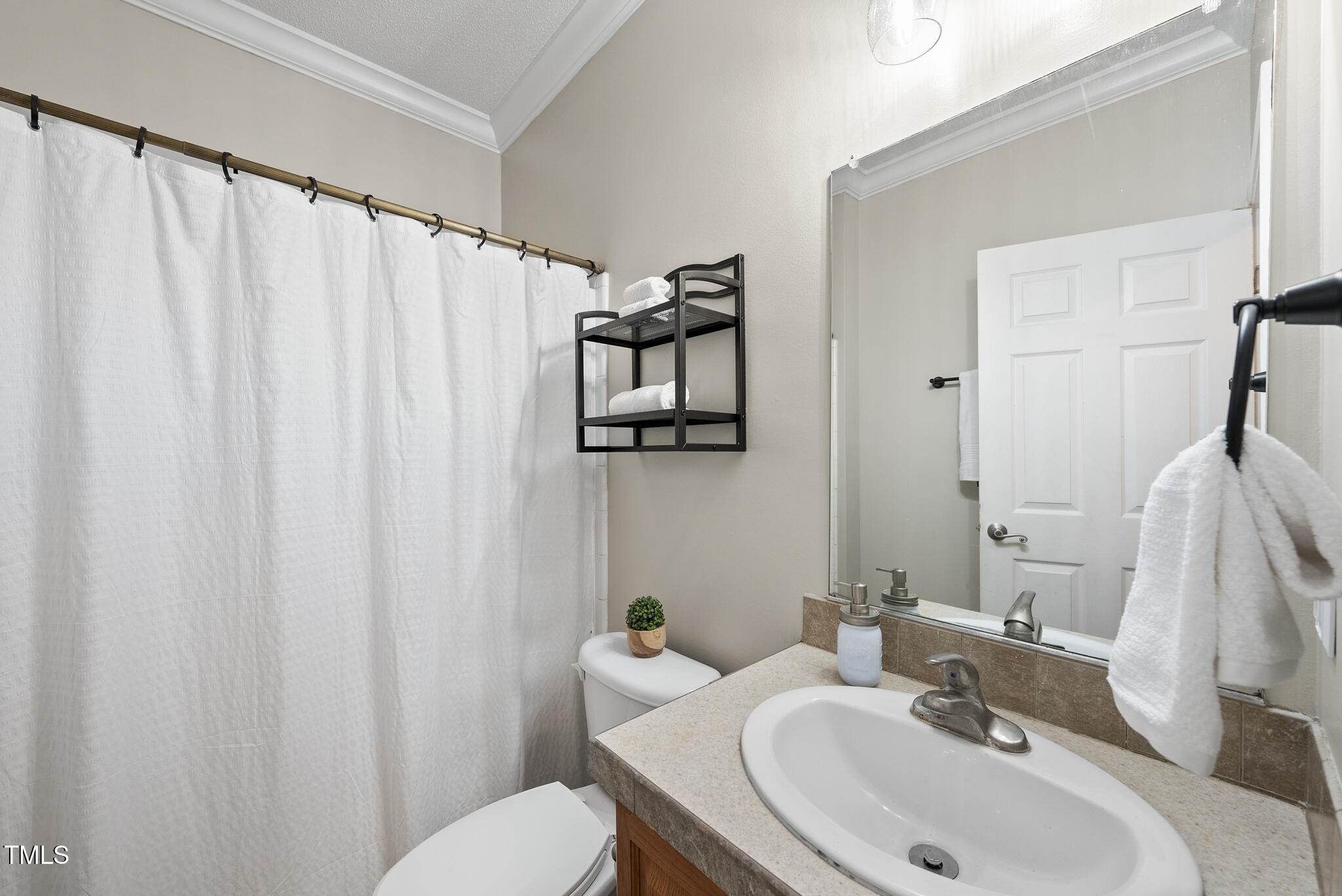 204 W Road Angier, NC 27501 - Photo 23 of 45 a bathroom with a sink vanity and toilet