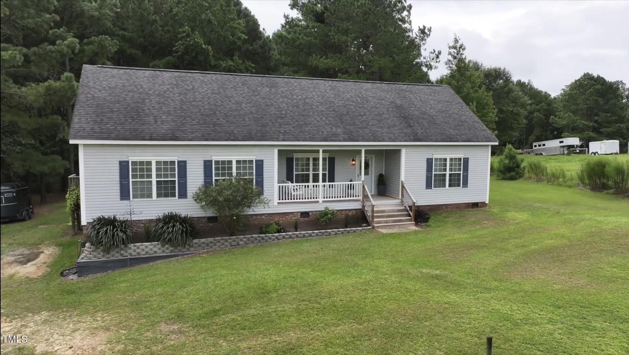 204 W Road Angier, NC 27501 - Photo 2 of 45 a view of a house with a yard and sitting area