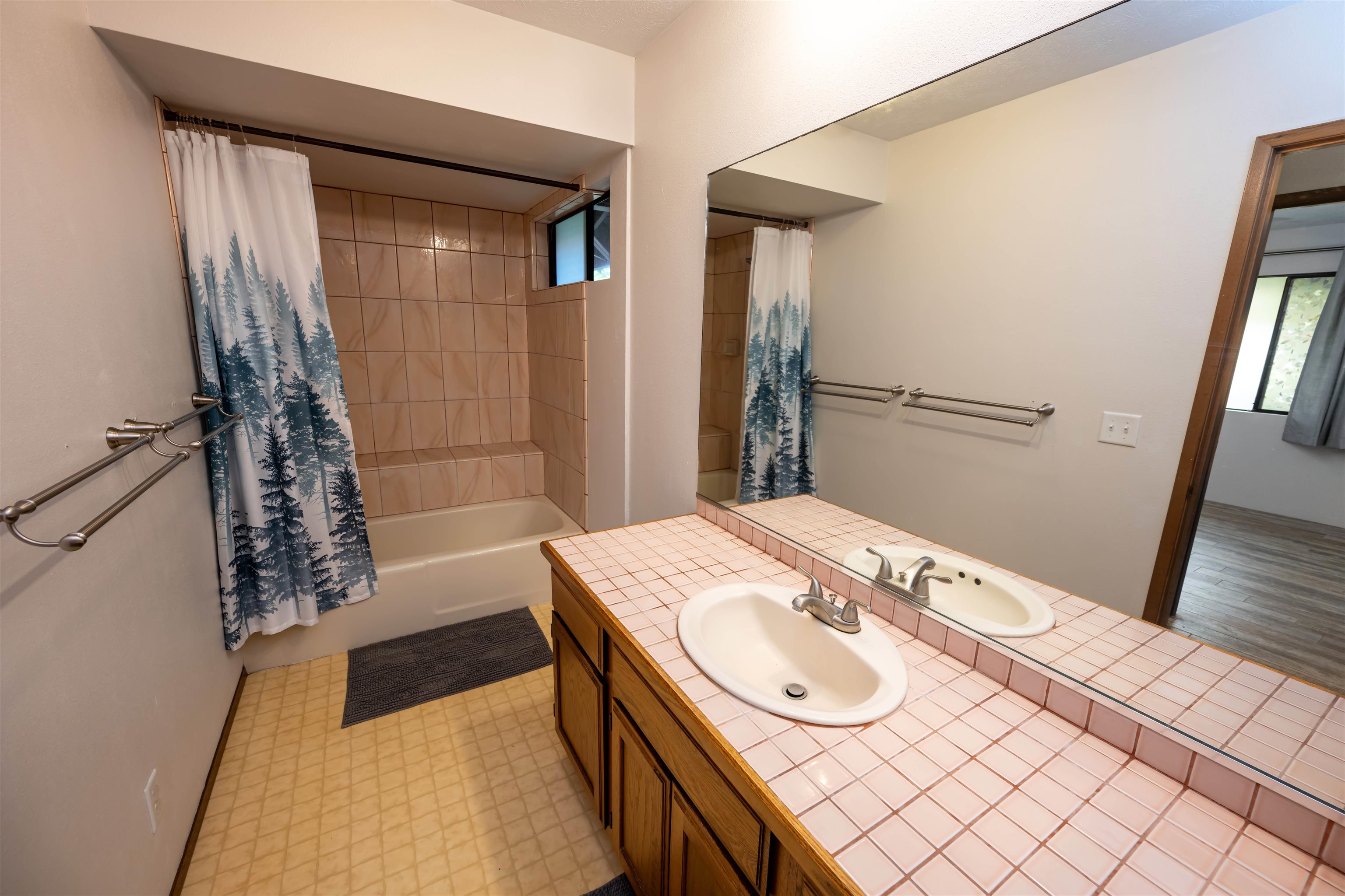 657 Mapuana Place Wailuku, HI 96793 - Photo 13 of 30 a bathroom with a sink a mirror and a shower