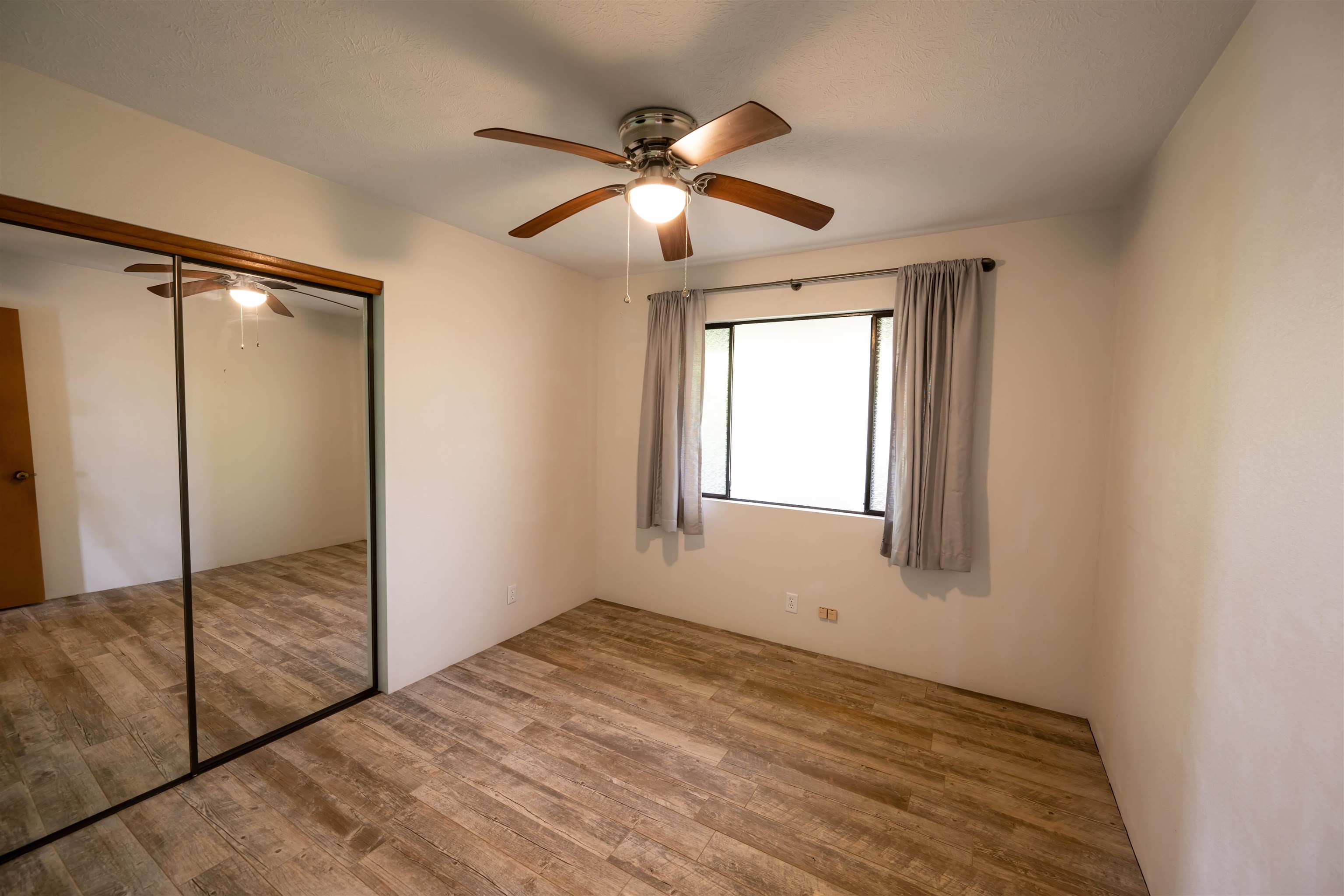 657 Mapuana Place Wailuku, HI 96793 - Photo 14 of 30 a view of a livingroom with a ceiling fan and window