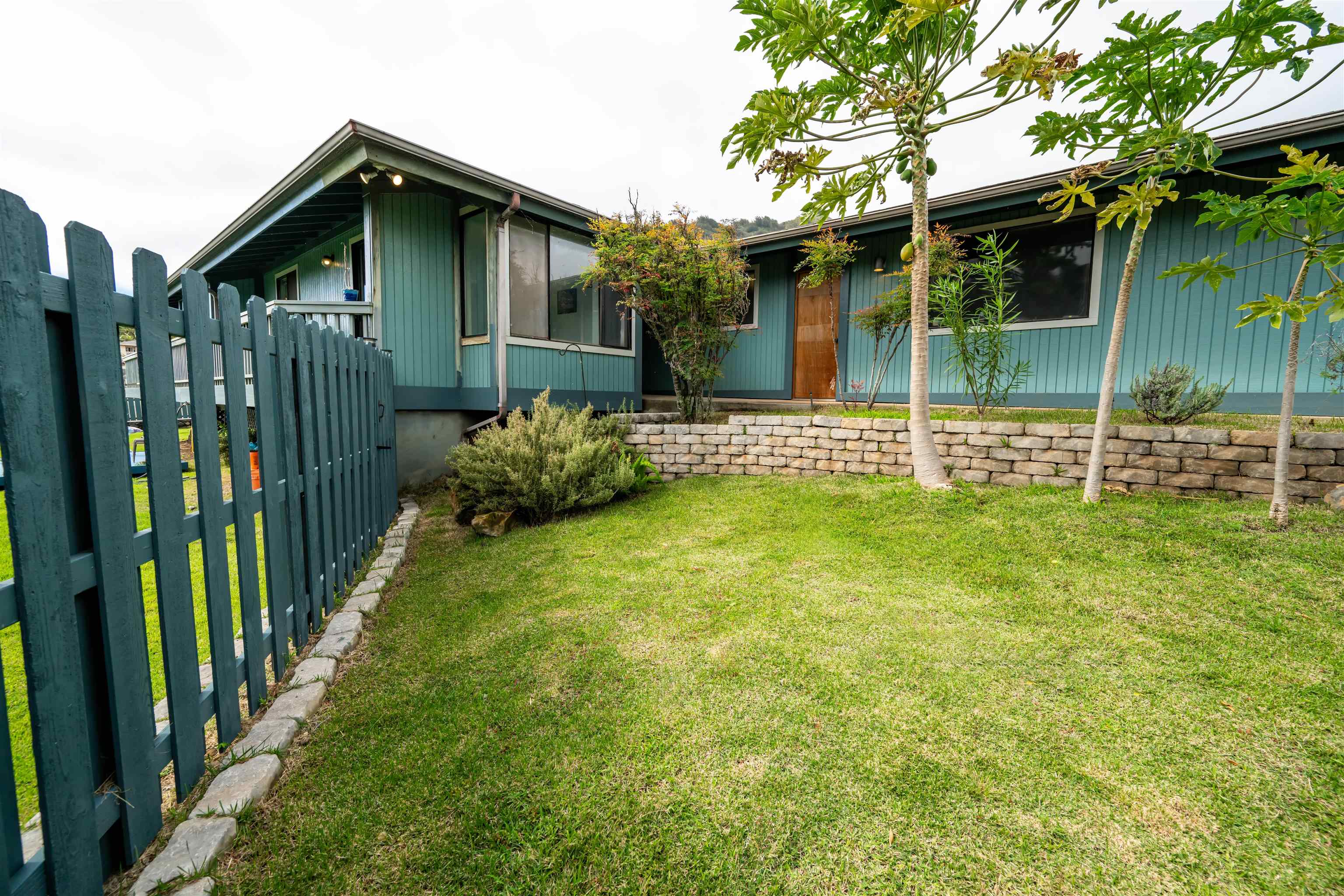 657 Mapuana Place Wailuku, HI 96793 - Photo 17 of 30 a view of a house with a small yard and a large tree