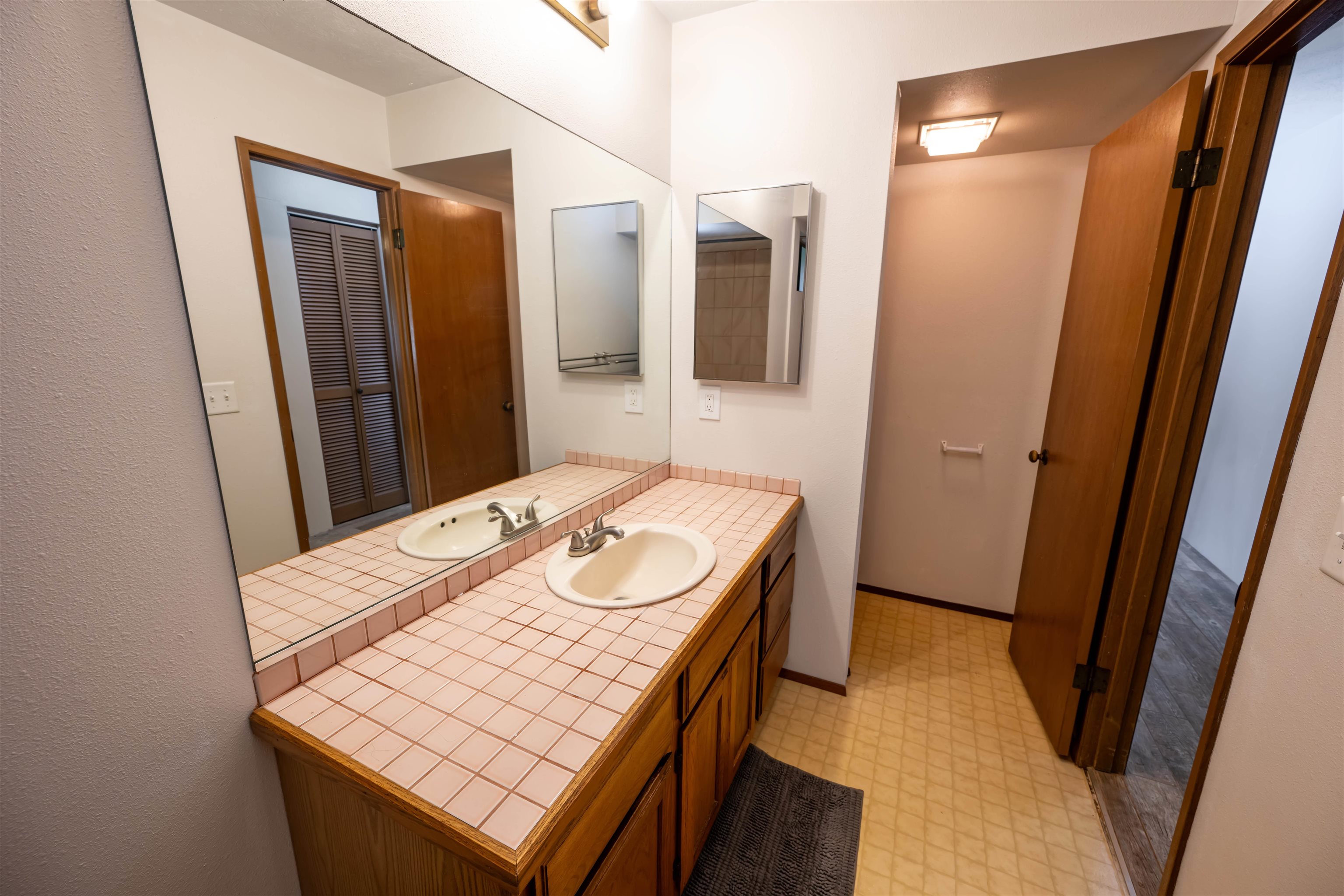 657 Mapuana Place Wailuku, HI 96793 - Photo 28 of 30 a bathroom with a sink a mirror and vanity