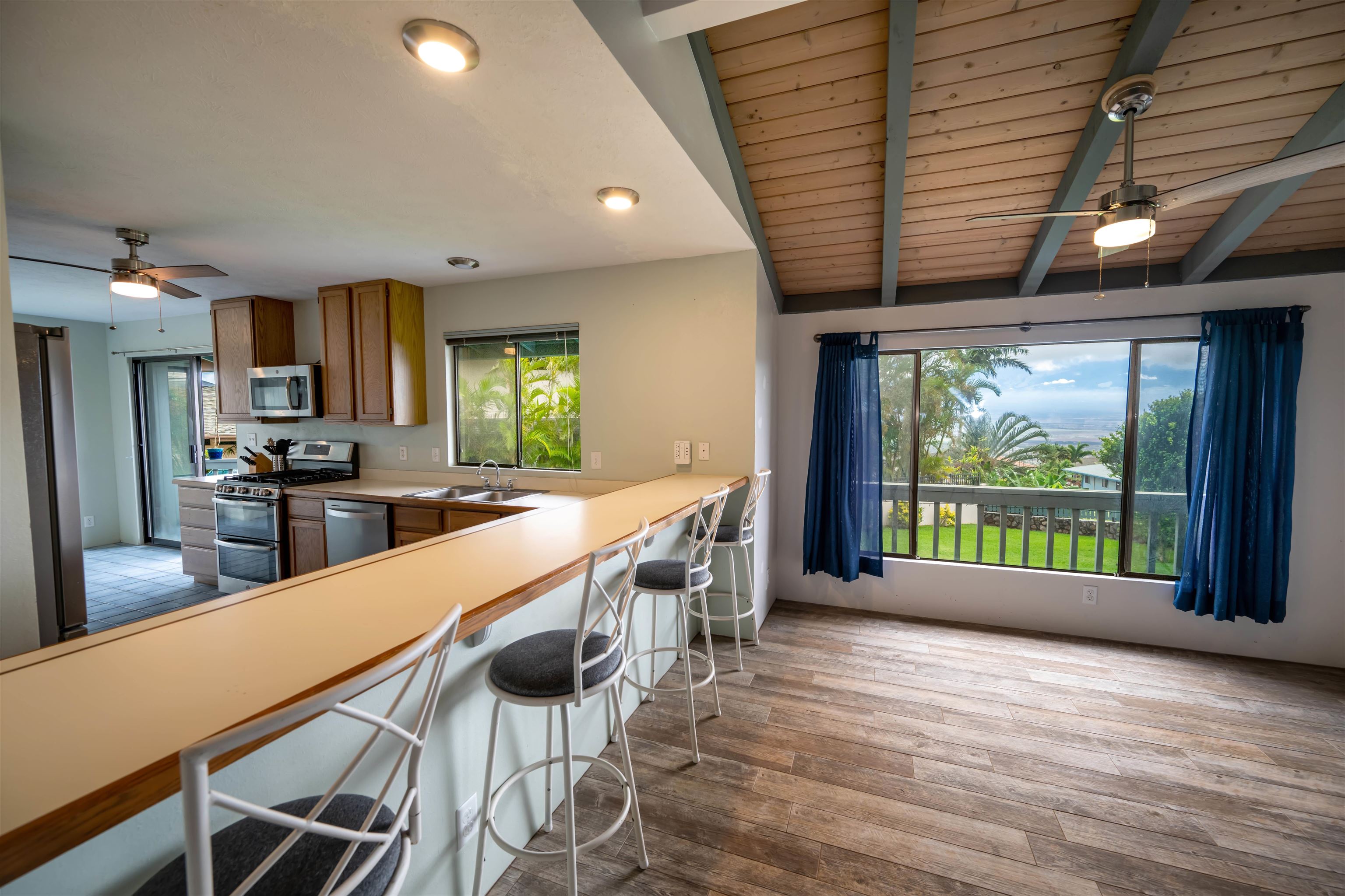 657 Mapuana Place Wailuku, HI 96793 - Photo 3 of 30 a large kitchen with kitchen island a large window a sink and stainless steel appliances