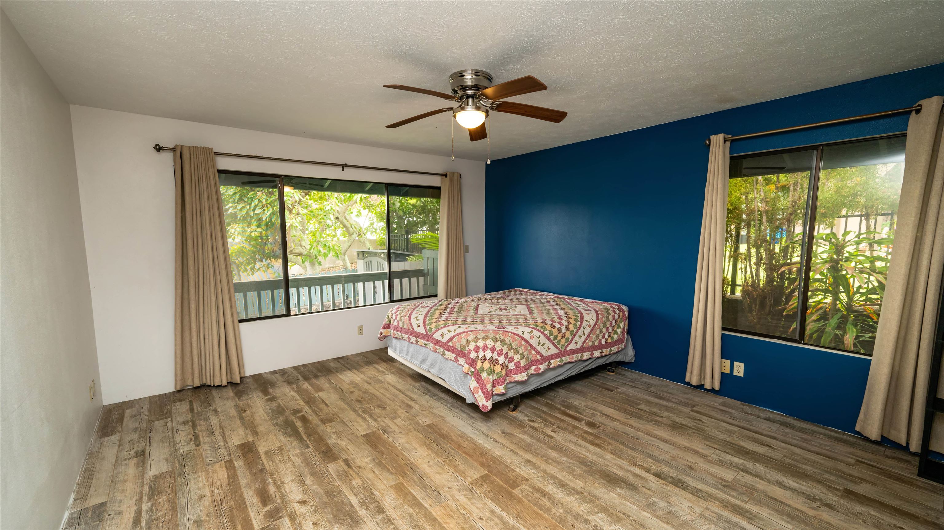 657 Mapuana Place Wailuku, HI 96793 - Photo 5 of 30 a bedroom with a large bed and a large window