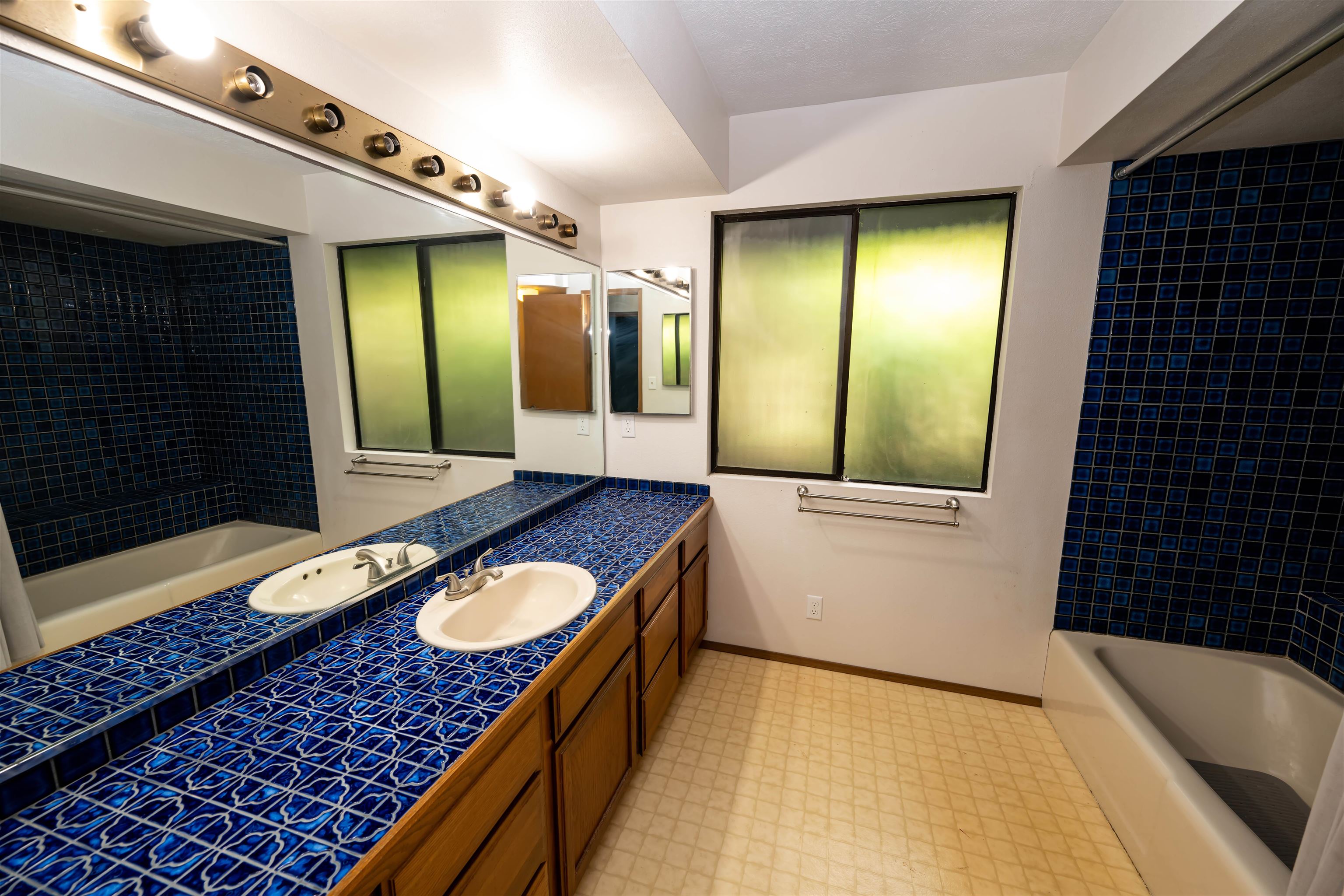 657 Mapuana Place Wailuku, HI 96793 - Photo 8 of 30 a bathroom with a granite countertop sink and a mirror