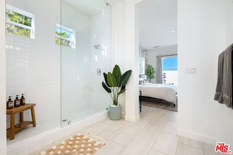 a bathroom with double sink and a mirror