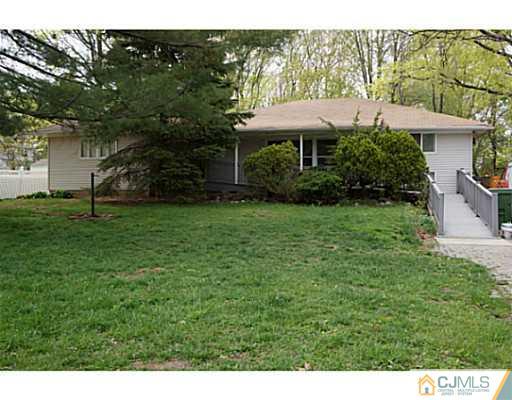59 Utica Road Edison, NJ 08820 - Photo 1 of 6 a front view of a house with a garden