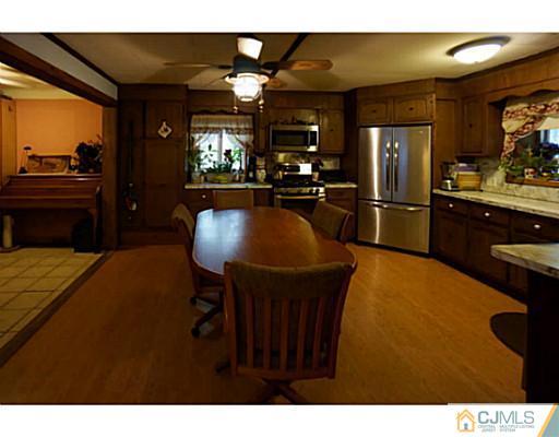 59 Utica Road Edison, NJ 08820 - Photo 3 of 6 a kitchen with stainless steel appliances granite countertop a sink refrigerator and cabinets