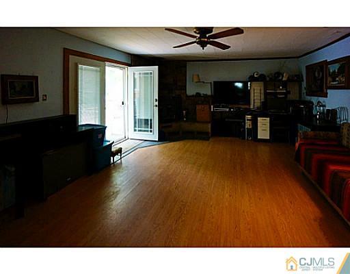 59 Utica Road Edison, NJ 08820 - Photo 5 of 6 a living room with furniture and a flat screen tv