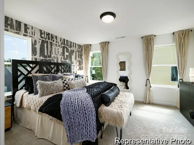 a living room with furniture fireplace and a large window