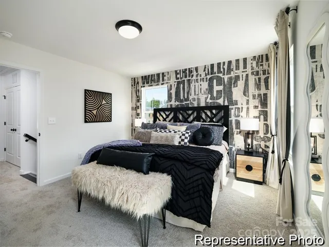 a bedroom with a bed and a night stand