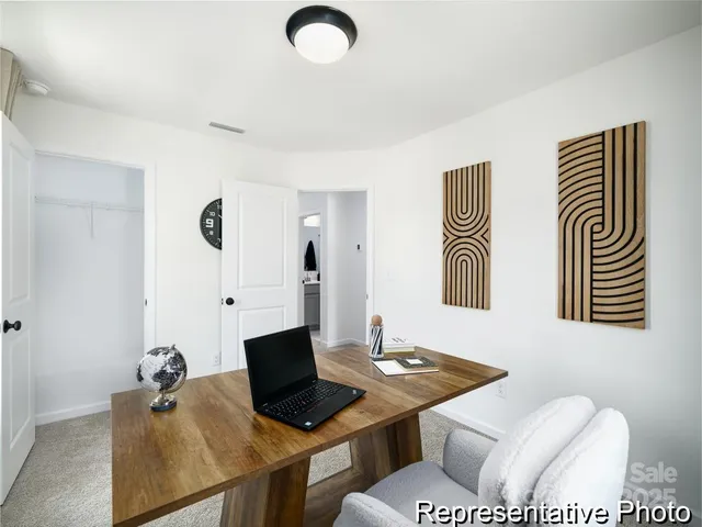 a view of a workspace with furniture