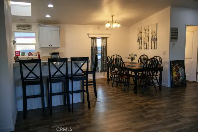 a view of a a dining room with furniture window and wooden floor