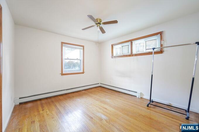 715 Main Street Caldwell, NJ 07006 - Photo 13 of 24 a view of a room with wooden floor and a ceiling fan