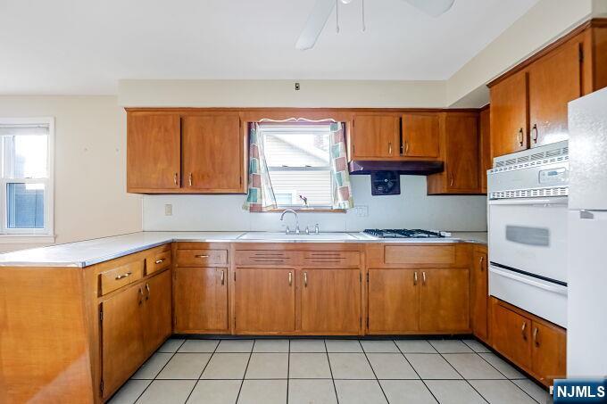715 Main Street Caldwell, NJ 07006 - Photo 9 of 24 a kitchen with a sink stove and cabinets